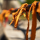 Orange cloth ribbons tied to a metal railing.